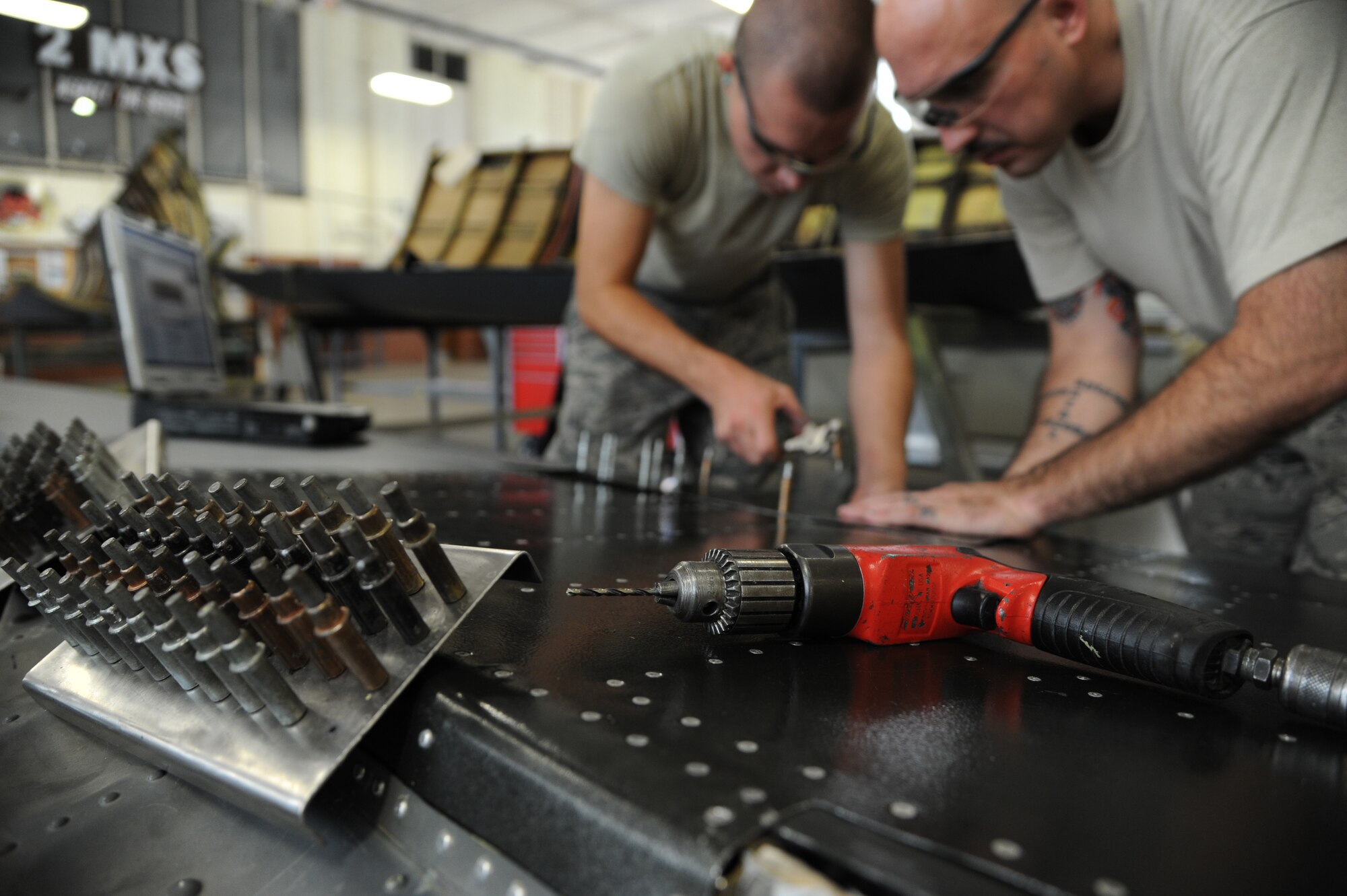 Airman 1st Class Blake Ruddel, left, 2nd Maintenance Squadron aircraft structural maintenance apprentice, and Tech. Sgt. Adam Joyce, 2nd MXS aircraft structural maintenance craftsman, place clecos, or temporary fasteners to a piece of sheet metal on Barksdale Air Force Base, La., Aug. 23, 2013. Ruddel and Joyce work together to drill holes and place clecos in the right elevator panel of a B-52H Stratofortress. (U.S. Air Force photo/Senior Airman Joseph A. Pagán Jr.)