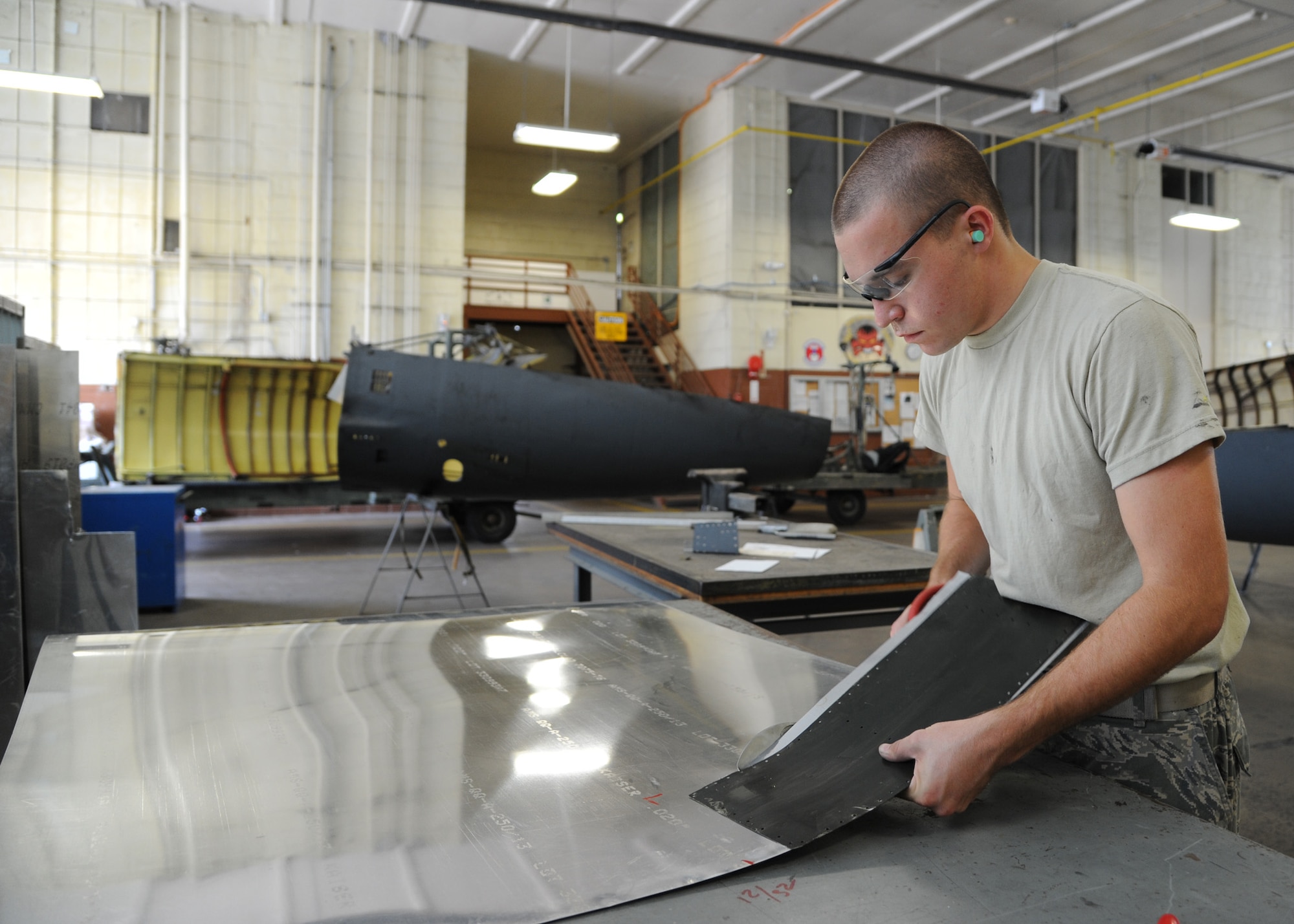Airman 1st Class Blake Ruddel, 2nd Maintenance Squadron aircraft structural maintenance apprentice, cuts a piece of sheet metal on Barksdale Air Force Base, La., Aug. 23, 2013. The piece of metal was fabricated to fit on the corner of the right elevator panel on a B-52H Stratofortress. The elevator panels control the up and down motion of the aircraft. (U.S. Air Force photo/Senior Airman Joseph A. Pagán Jr.)