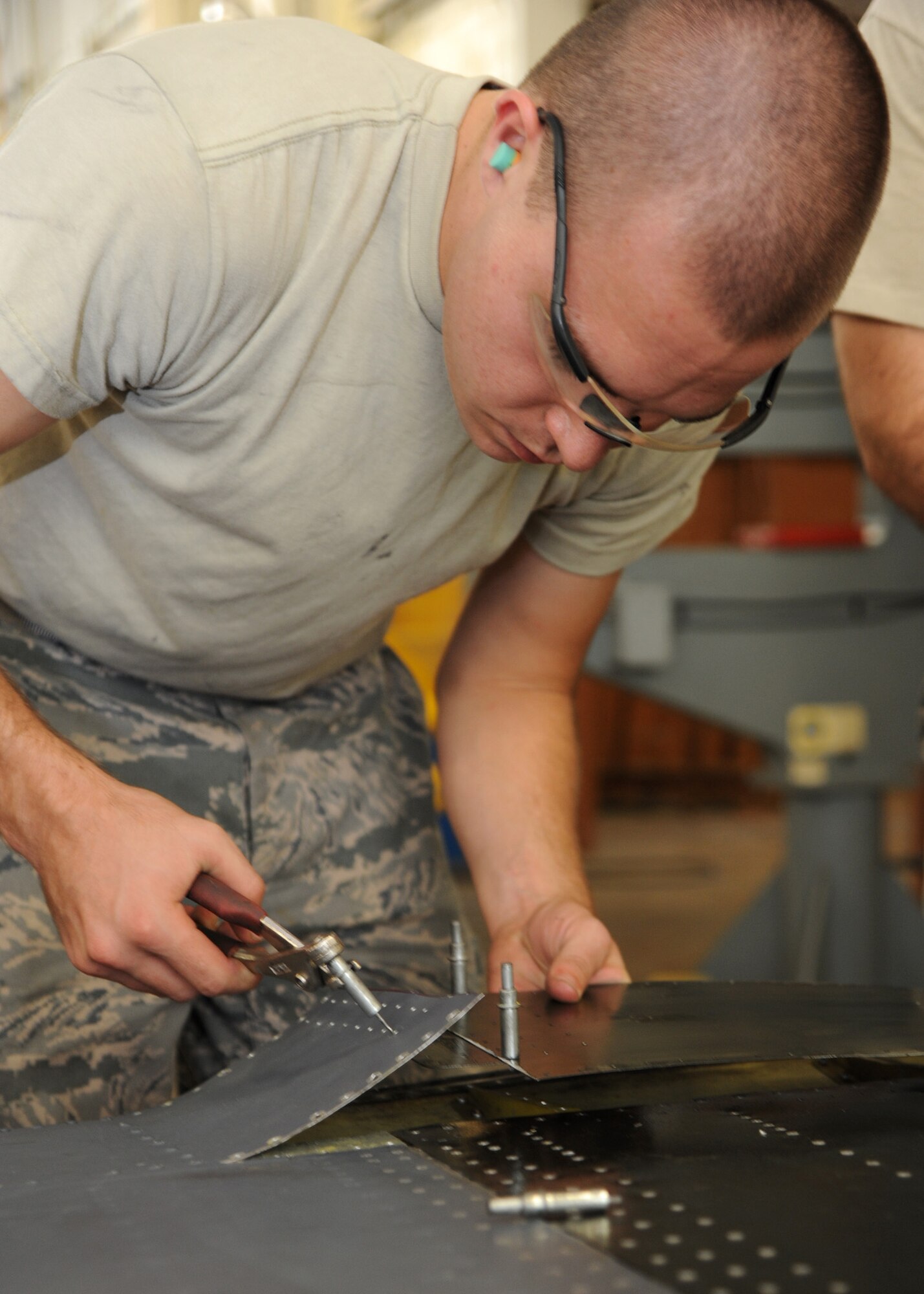 Airman 1st Class Blake Ruddel, 2nd Maintenance Squadron aircraft structural maintenance apprentice, uses clecos, or temporary fasteners, to hold two pieces of sheet metal in place on Barksdale Air Force Base, La., Aug. 23, 2013. Ruddel rebuilt a rib on the right elevator panel of a B-52H Stratofortress, and then covered it with sheet metal. Ribs are essentially the foundation under the sheet metal which help form the skeletal structure of the panel. (U.S. Air Force photo/Senior Airman Joseph A. Pagán Jr.)
