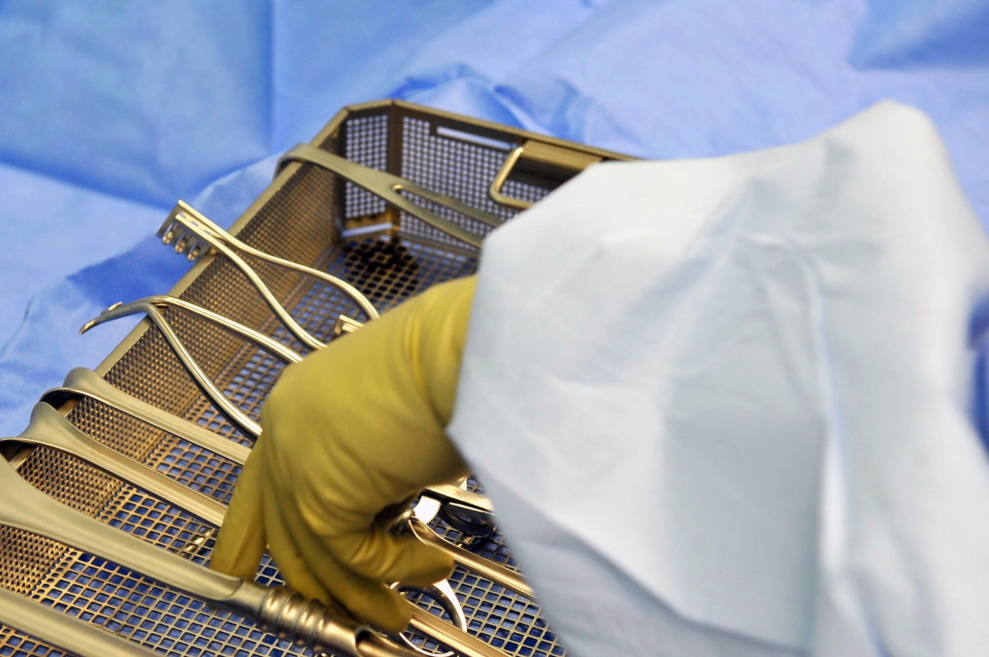 Airman 1st Class Kathryn Presser, 86th Medical Squadron surgical technician prepares tools during a new versus old school challenge Aug. 22, 2013 at Landstuhl Regional Medical Center, Germany. The challenge was who could set tools up the quickest; an Airman or the superintendant of the medical group. (U.S. Air Force photo/Senior Airman Trevor Rhynes)  