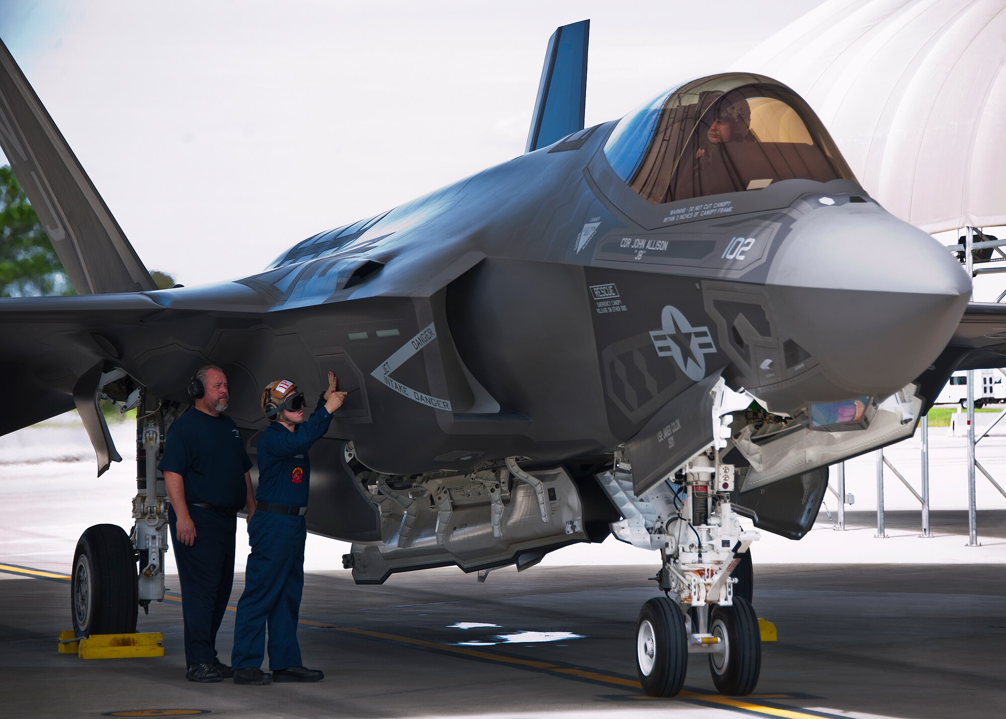 A Sailor uses a tool to open a compartment on the Navy variant F-35C Lightning II after a sortie at Eglin Air Force Base, Fla.  The Sailors from the Strike Fighter Squadron-101, along with Airmen and Marines work directly with the LM maintainers to help put the joint strike fighters in the air.  (U.S. Air Force photo/Samuel King Jr.)