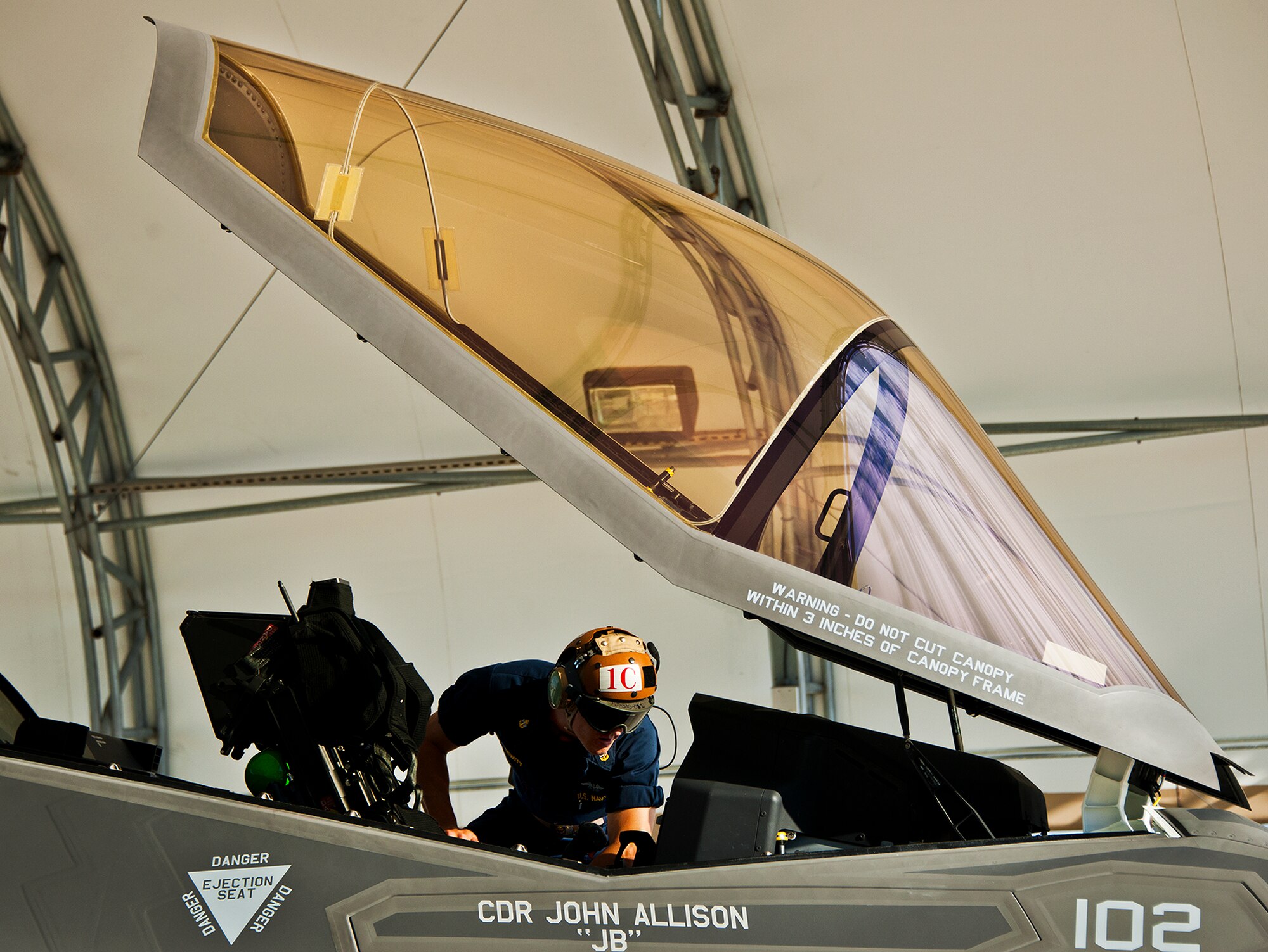 Chief Petty Officer Ben DeWitt, of the Strike Fighter Squadron-101, preforms pre-flight checks on an F-35C Lightning II prior to a sortie at Eglin Air Force Base, Fla.  Sailors, along with Airmen and Marines work directly with the LM maintainers to help put the joint strike fighters in the air.  (U.S. Air Force photo/Samuel King Jr.)