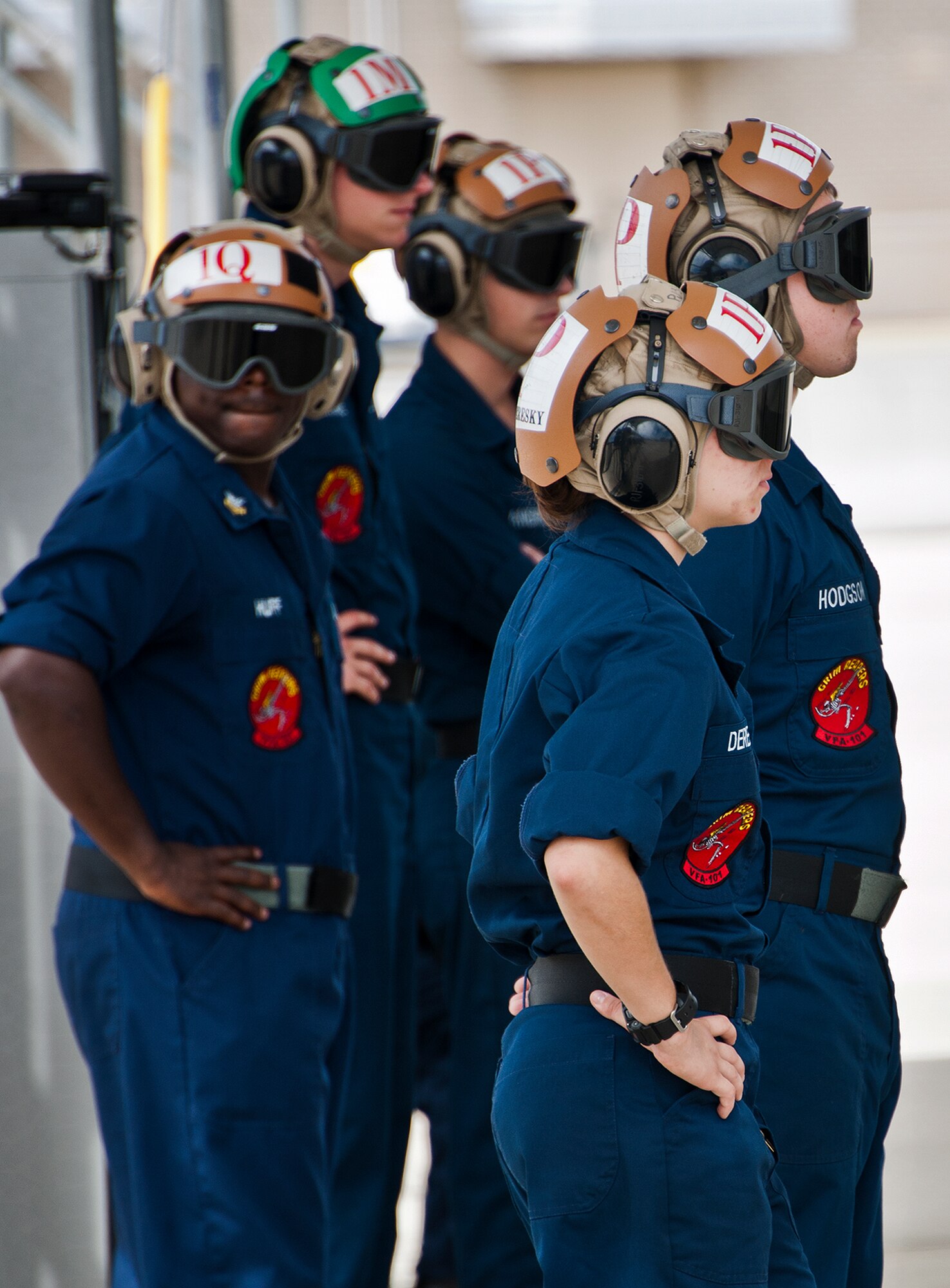Sailors with the Strike Fighter Squadron-101 watch the preflight procedures closely prior to an F-35C Lightning II sortie at Eglin Air Force Base, Fla.  Sailors, along with Airmen and Marines work directly with the LM maintainers to help put the joint strike fighters in the air.  (U.S. Air Force photo/Samuel King Jr.)