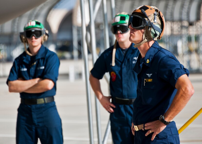 Chief Petty Officer Ben DeWitt, of the Strike Fighter Squadron-101, monitors pre-flight checks prior to an F-35C Lightning II sortie at Eglin Air Force Base, Fla.  Sailors, along with Airmen and Marines work directly with the LM maintainers to help put the joint strike fighters in the air.  (U.S. Air Force photo/Samuel King Jr.)