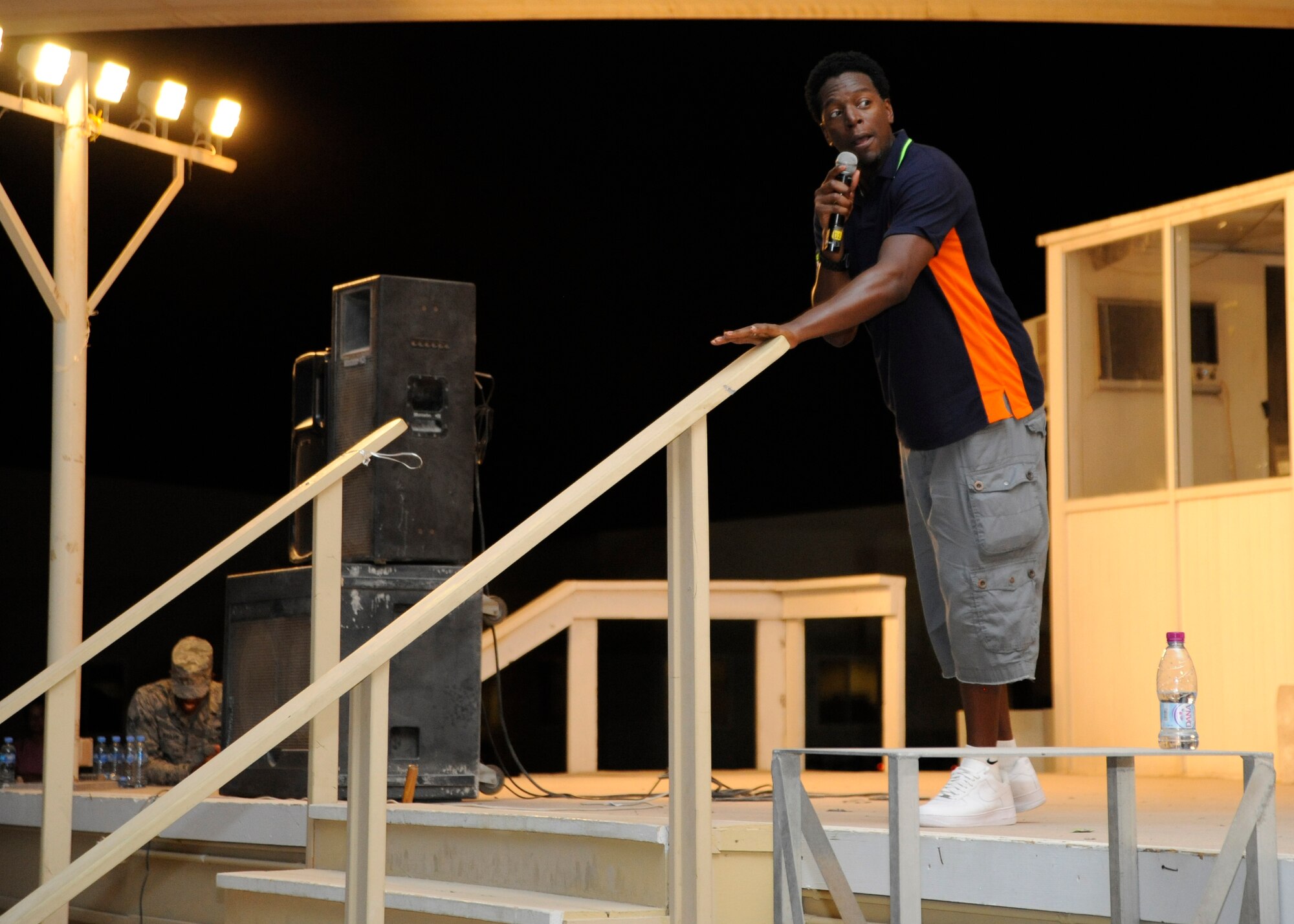 Comedian Dean Edwards tells jokes to a Grand Slam audience during a comedy tour performance at the 379th Air Expeditionary Wing in Southwest Asia, Aug. 24, 2013. Edwards made his big break on Russell Simmons’ “Def Comedy Jam” and has since made countless television appearances and spent two seasons on the cast of “Saturday Night Live.” The former Army soldier said he appreciates the sacrifices service members make every day. (U.S. Air Force photo/Senior Airman Bahja J. Jones) 