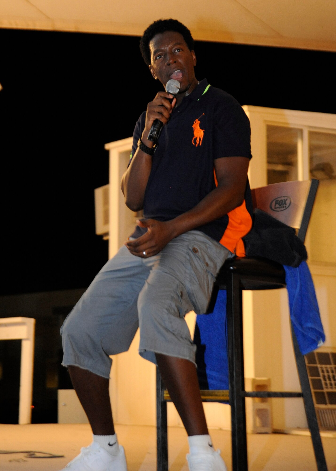 Comedian Dean Edwards tells jokes to a Grand Slam audience during a comedy tour performance at the 379th Air Expeditionary Wing in Southwest Asia, Aug. 24, 2013. Edwards made his big break on Russell Simmons’ “Def Comedy Jam” and has since made countless television appearances and spent two seasons on the cast of “Saturday Night Live.” The former Army soldier said he appreciates the sacrifices service members make every day. (U.S. Air Force photo/Senior Airman Bahja J. Jones) 