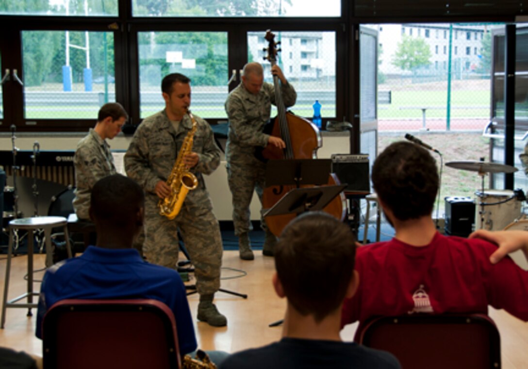 Left to Right: SrA Mike Mitchell, SSgt Lencys Esteban-Nunez, and SrA Joe Whitt perform "Anthropology" for Ramstein and Kaiserslautern High School students.  The Ambassadors Jazz Combo conducted a masterclass focusing on various aspects of jazz improvisation ending with a "jam session" which included all students in attendance.