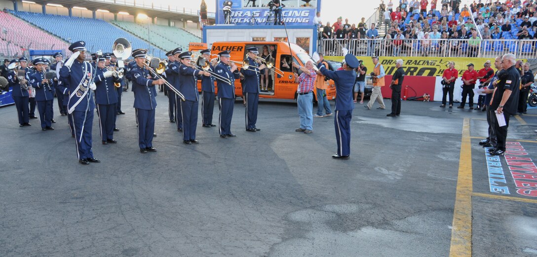 The USAFE Marching Band performs the German and U.S. national anthems at the 2013 NitrOlympx Drag Racing competition.  This event was sponsored by the USO Germany in dedication of the 'Wounded Warrior" project.