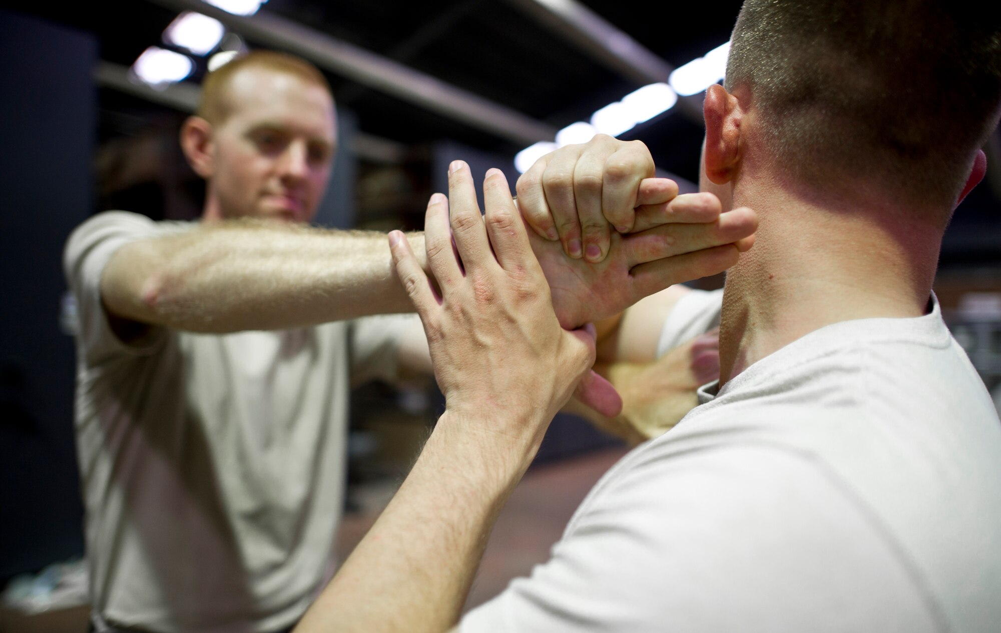 YOKOTA AIR BASE, Japan— Staff Sgt. Justin Barnes, 374th Security Forces Squadron, performs a submission hold, based on pressure point control and physical apprehension restraint techniques, during Fly-away security training at Yokota Air Base, Japan, Aug. 19-23, 2013. Students received hands-on practical training in subjects such as self-defense and anti-hijacking training. Fly-away security team members, who are embedded in an aircrew, travel with any Yokota aircraft that travels into potentially dangerous areas of the Pacific Region to protect the aircraft and aircrew from potential threats. (U.S. Air Force photo by Staff Sgt Stacy Moless)
