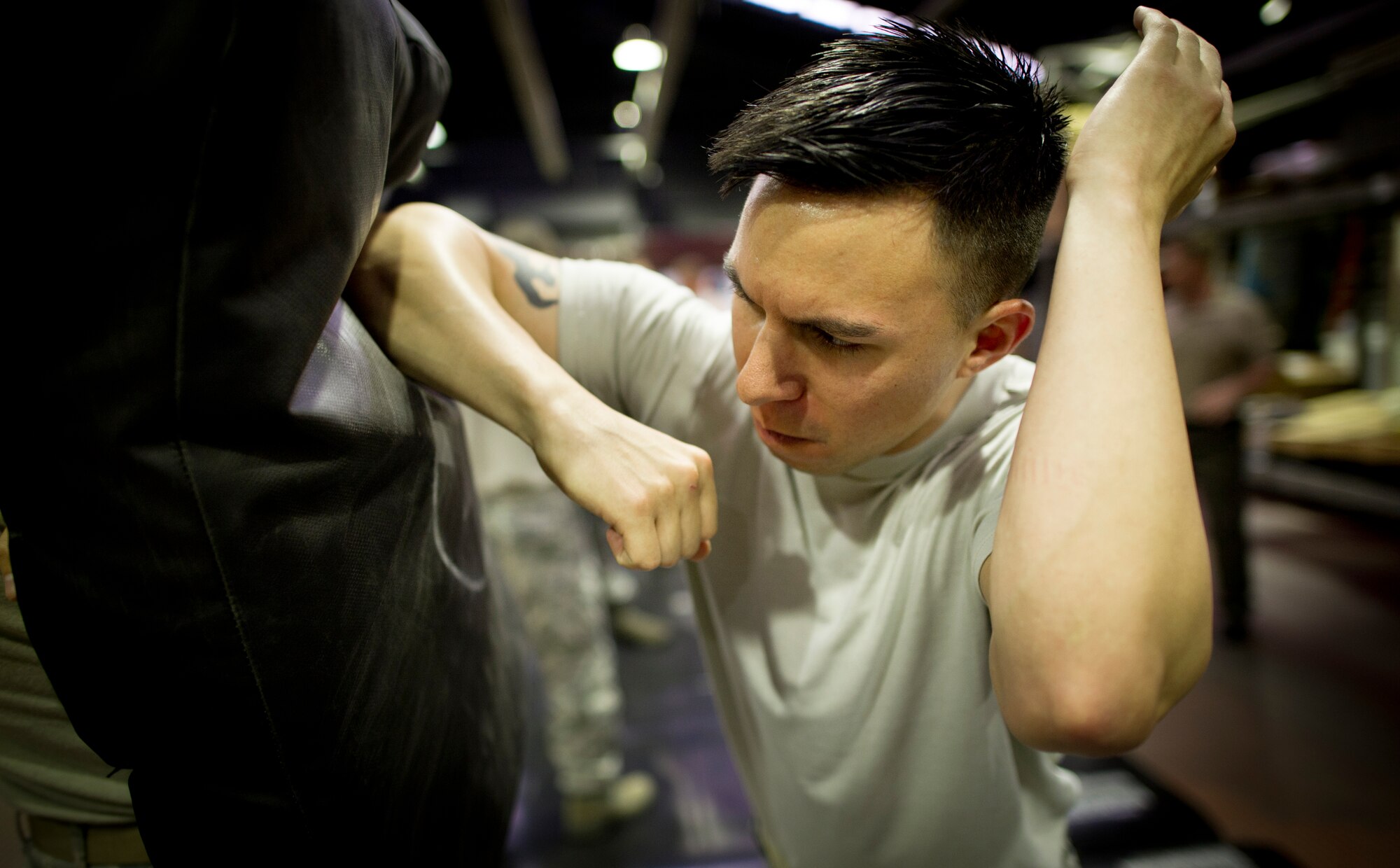 YOKOTA AIR BASE, Japan—Senior Airman Nichols Mullinnix, 374th Security Forces Squadron, elbows a punching bag during Fly-away security training at Yokota Air Base, Japan, Aug. 19-23, 2013. Students received hands-on practical training in subjects such as self-defense and anti-hijacking training.  Fly-away security team members, who are embedded in an aircrew, travel with any Yokota aircraft that travels into potentially dangerous areas of the Pacific Region to protect the aircraft and aircrew from potential threats. (U.S. Air Force photo by Staff Sgt Stacy Moless)