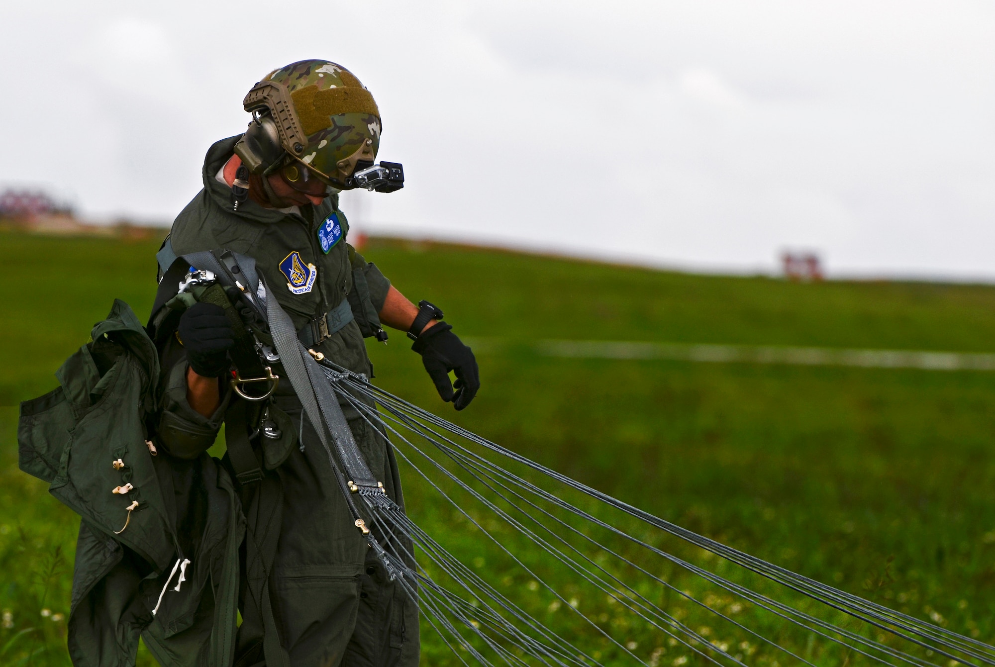 Staff Sgt. Stephen Baker, 736th Security Forces Squadron parachute program manager, stands up Aug.21, 2013 after landing on the drop zone during static line jump training on Andersen Air Force Base, Guam. Air Force static line capability falls under the personnel parachute program. Jumpers are first qualified during a three-week long basic airborne course at Ft. Benning, Ga., and then continue to work on their jumping proficiency and qualifications after they return here. (U.S. Air Force photo by Airman 1st Class Marianique Santos/Released)
