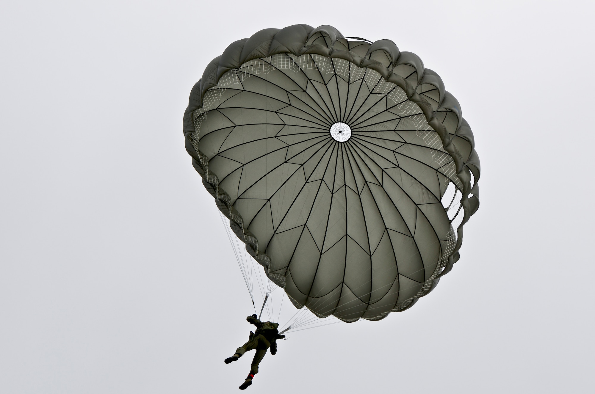 A member of the 736th Security Forces Squadron makes his way to the ground Aug. 21, 2013, during a static line jump over the Andersen Air Force Base, Guam, flightline. Air Force static line capability falls under the personnel parachute program. Jumpers are first qualified during a three-week long basic airborne course at Ft. Benning, Ga., and then continue to work on their jumping proficiency and qualifications after they return here. (U.S. Air Force photo by Airman 1st Class Marianique Santos/Released)