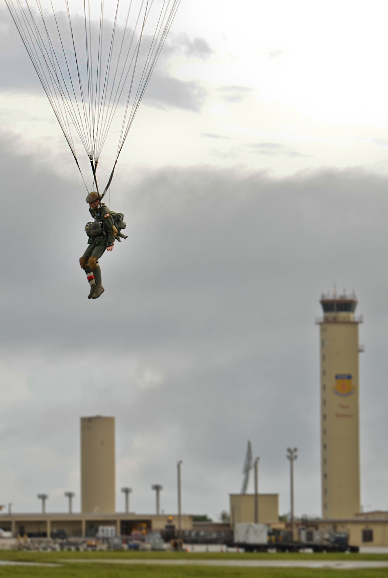 Staff Sgt. Jacob Thompson, 736th Security Forces Squadron fire team leader and jumpmaster, makes his way to the ground after a static line jump from a C-130 Hercules over the Andersen Air Force Base, Guam, flightline Aug. 21, 2013. As the integrated force protection element of the 36th Contingency Response Group, members of the 736th SFS provide a quick-response airborne capability that serves as an advance echelon team for contingency and humanitarian missions all over the Asia-Pacific region. (U.S. Air Force photo by Airman 1st Class Marianique Santos/Released)