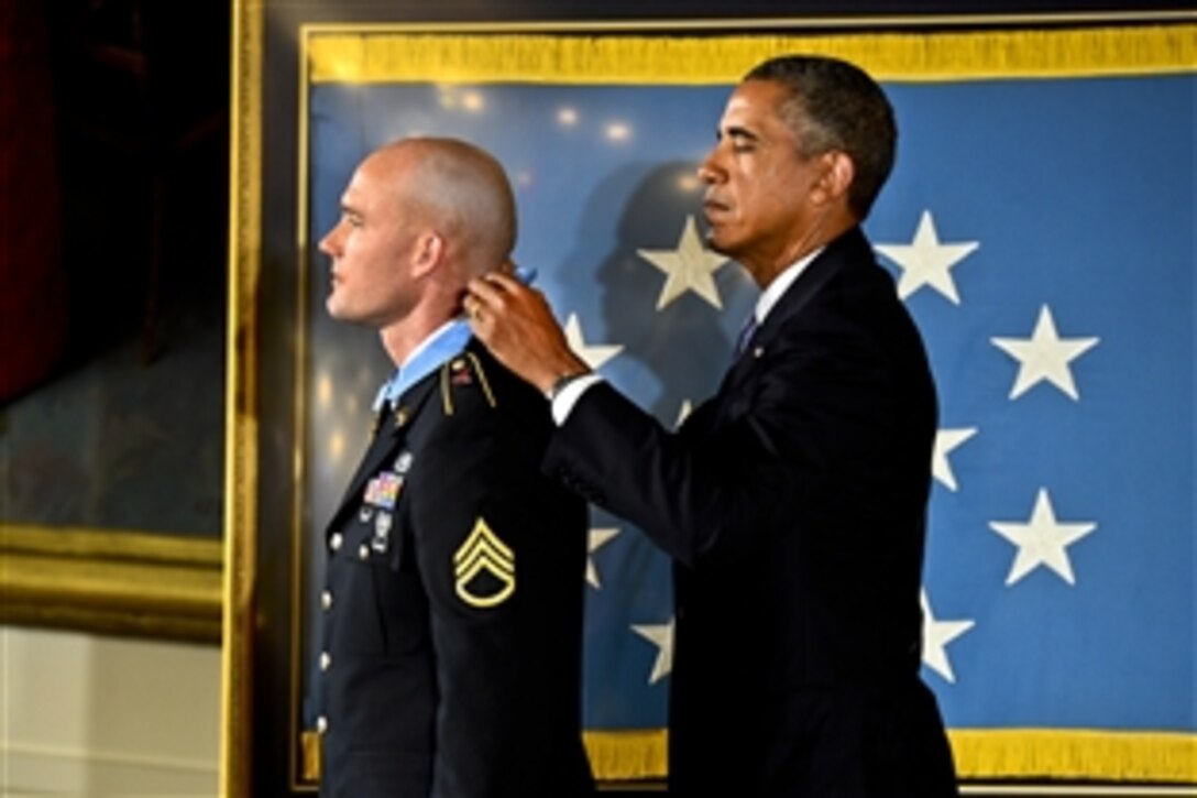 President Barack Obama presents Army Staff Sgt. Ty Michael Carter with the Medal of Honor at the White House, Aug. 26, 2013, for his actions during the Oct. 3, 2009, battle on Combat Outpost Keating in Nuristan province, Afghanistan.