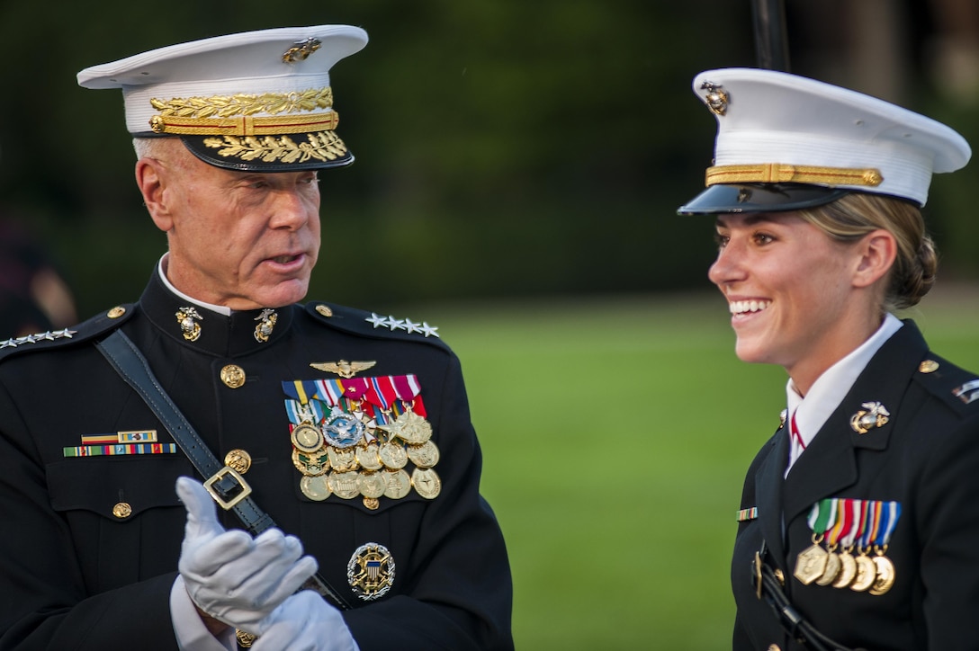 Gen. James Amos, commandant of the U.S. Marine Corps, speaks with Capt. Lorelei Gaus, protocol officer at Marine Barracks Washington, D.C., prior to the start of a parade held at the Barracks for the Brigadier General Select Orientation Course, Aug. 26. (Official Marine Corps photo by Lance Cpl. Dan Hosack/Released)