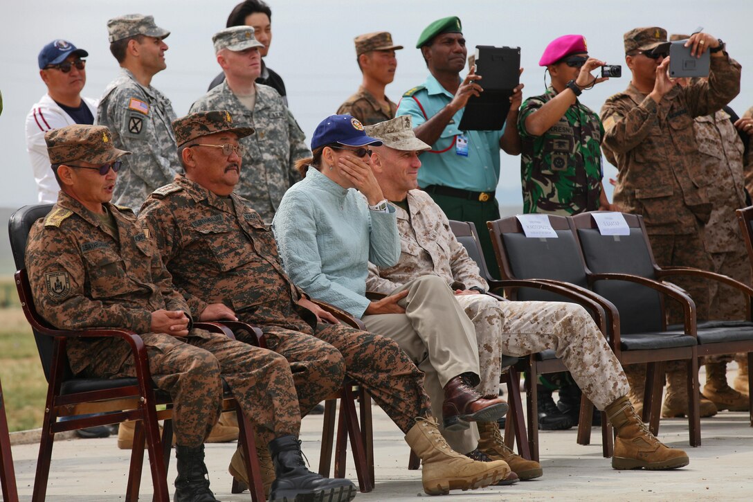 Lt. Gen. Ts. Byambajav, Chief of General Staff, Mongolian Armed Forces; U.S. Ambassador to Mongolia Piper Campbell; and Brig. Gen. Richard Simcock, deputy commander for U.S. Marine Corps Forces, Pacific; react to a demonstrator being stunned by an X26 Taser at Five Hills Training Area, Mongolia, Aug. 26. The demonstration was part of a ceremony marking the conclusion of the field training exercise and start of the leadership portion during the Non-Lethal Weapons Executive Seminar. NOLES is hosted annually in the Pacific region and led this year by U.S. Marines with 3rd Law Enforcement Battalion, III Marine Expeditionary Force. Mongolia, a regular participant, is hosting NOLES for the third time in 12 years. MarForPac serves as the executive agent for the exercise every year.