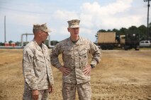 Lt. Gen. Richard T. Tryon (center), the commanding general of U.S. Marine Corps Forces Command and U.S. Marine Forces Europe, speaks with Lt. Col. Matthew A. Dumenigo (left), the commanding officer of Combat Logistics Battalion 24, 2nd Marine Logistics Group, during a Defense Support of Civil Authorities, or DSCA, training exercise, aboard Naval Amphibious Base Little Creek, Va., Aug. 21, 2013. The battalion practiced DSCA operations during a three-day exercise in preparation for possible humanitarian missions during natural disasters.