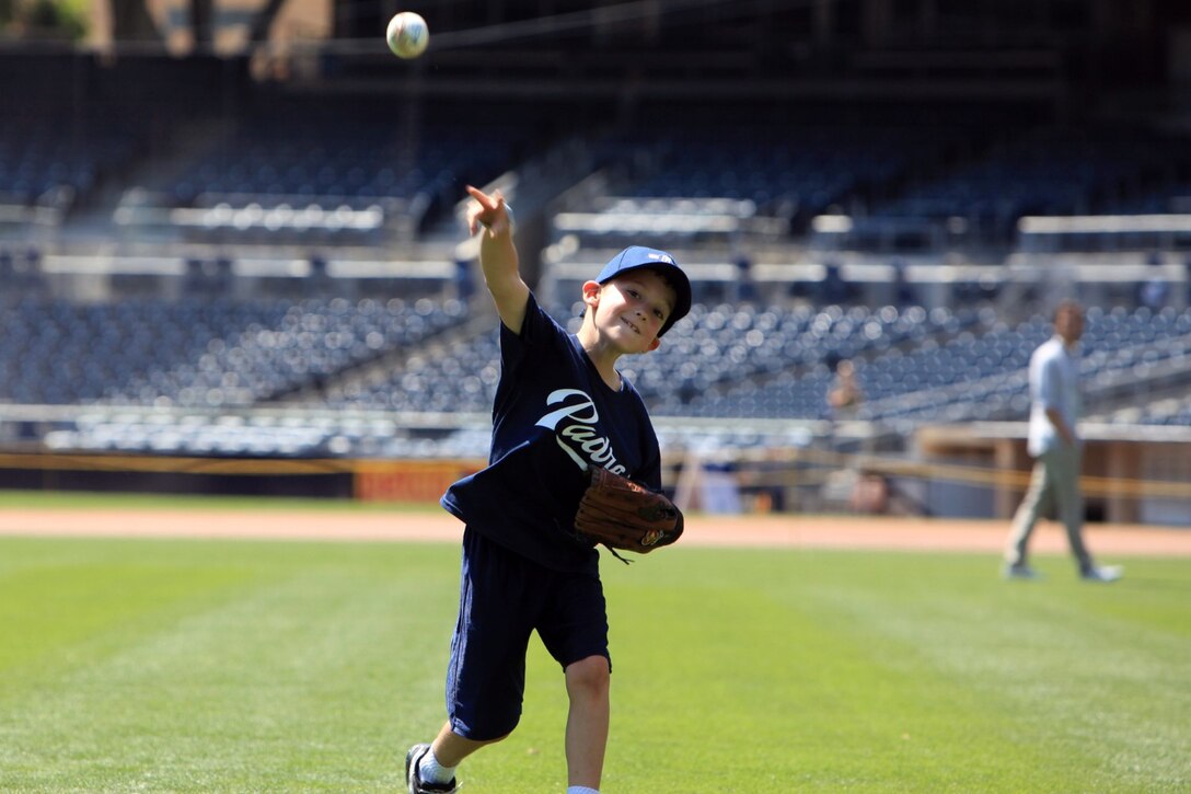 Henry Summers, throws a pitch while participating in a baseball clinic hosted by the Padres Foundation and USAA at Petco Park, Aug. 22. The clinic was designed to thank service members and their families from across San Diego, for their service. The clinic taught the children teamwork, agility, fielding, batting and pitching.