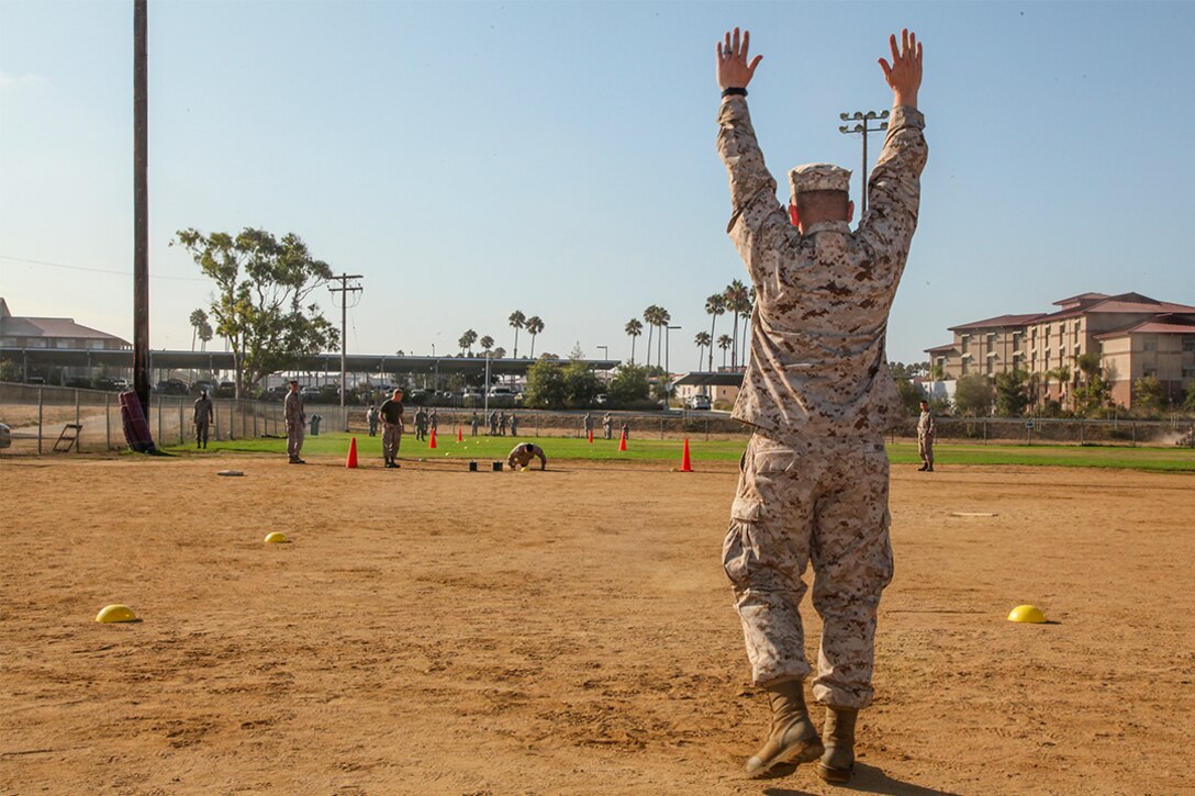 Corporal Adam Vincent, Marine Air-Ground Task Force planning specialist, Command Element, 15th Marine Expeditionary Unit, raises his hands signaling a hit during a unit Combat Fitness Test aboard Camp Pendleton, Calif., Aug. 21, 2013. Vincent, 30, is from Schenectady, N.Y. (U.S. Marine Corps Photo by Cpl. Emmanuel Ramos/Released)