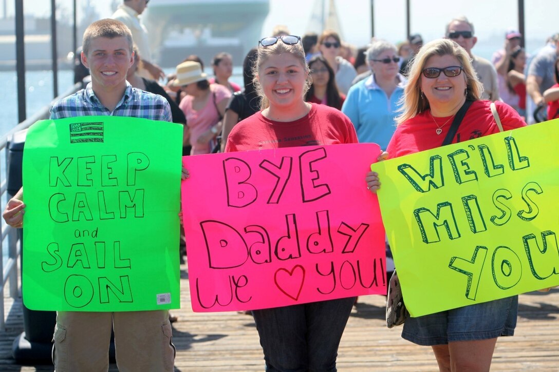 Family members of Marines and sailors with the 13th Marine Expeditionary Unit wave farewell as the USS Boxer departs for deployment out of Naval Base San Diego, Calif., Aug. 23. More than 2,400 Marines and sailors with the 13th MEU departed for deployment with the Boxer Amphibious Ready Group.