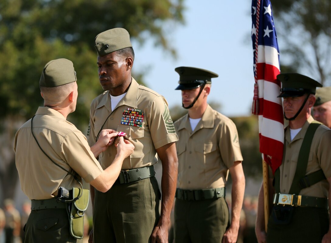 MARINE CORPS BASE CAMP PENDLETON, Calif. – Sergeant Maj. Clifford Wiggins, the outgoing sergeant major of 3rd Assault Amphibian Battalion, stands at attention as he is awarded his fourth Meritorious Service Medal during a relief and appointment ceremony here, Aug. 23, 2013. Wiggins, a native of Cincinnati, is slated to become the sergeant major of 5th Marine Regiment after Sgt. Maj. Michael P. Woods took over as 3rd AABn. sergeant major.