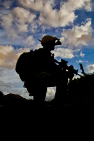 A Marine serving with Alpha Company, 1st Reconnaissance Battalion, posts security during a night raid for a mission rehearsal exercise here, Aug. 19, 2013. The Marines landed under the cover of darkness as they continued their training for the 11th Marine Expeditionary Unit. During the exercise, role-players were used to make the scenarios as realistic as possible.
