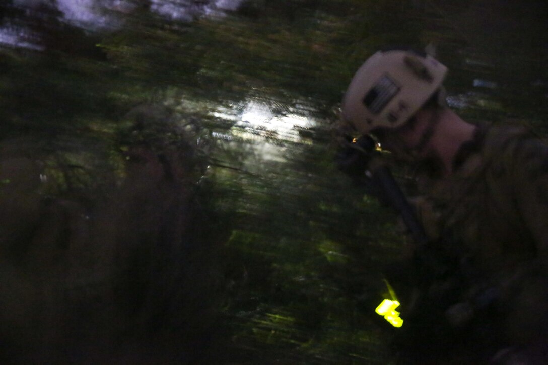 Marines serving with Alpha Company, 1st Reconnaissance Battalion, move under the cover of darkness during a mission rehearsal exercise here, Aug. 19, 2013. The exercise allowed the Marines' command element to assess where they were in their training as they prepare to deploy with the 11th Marine Expeditionary Unit.
