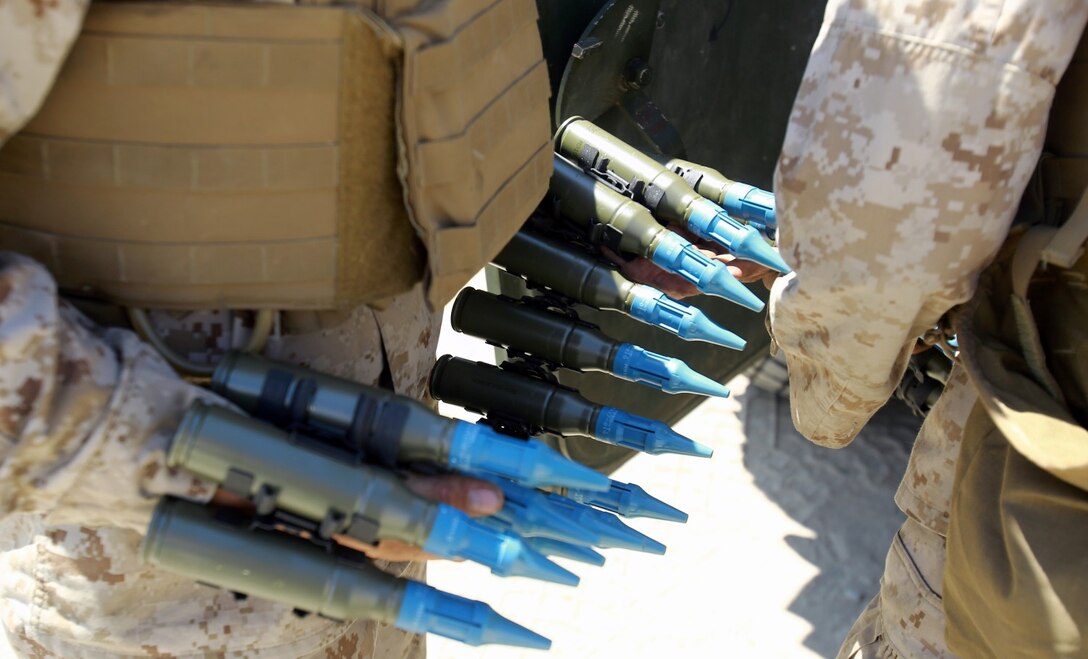 Marines serving with Alpha Company, 1st Light Armored Reconnaissance Battalion, load 25 mm rounds into the M242 Bushmaster machine gun during a training exercise here, Aug. 20, 2013. The purpose of the exercise was to cross train the riflemen serving with 1st LAR on the weapons systems of the light armored vehicle. The riflemen must know how to operate and maintain the light armored vehicles' weapons systems in preparation for future combat operations.