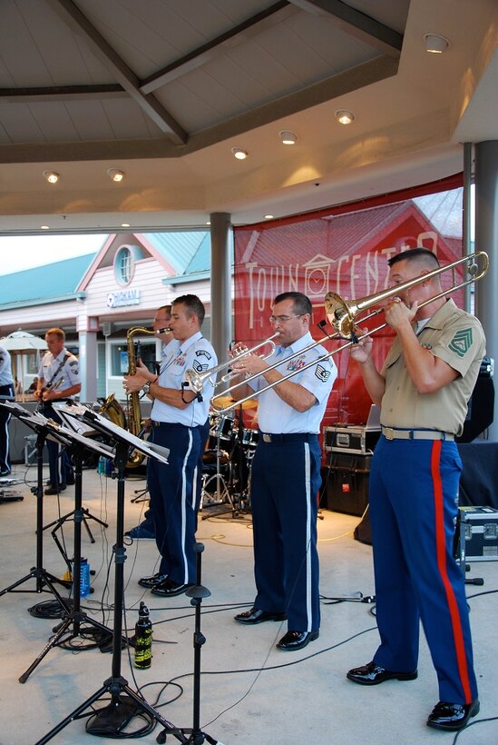 MILILANI, Hawaii -- Gunnery Sergeant Mark Lemstrom, Marine Corps Forces Pacific Fleet Band, joins forces with the Air Force Band of the Pacific-Hawaii,on the trombone,at the Mililani Concert Series in Mililani,Hawaii, Aug. 9, 2013. The Band of the Pacific-Hawaii participated in three summer concerts in Mililani. The concert series helped build stronger community relations with the town, and the hundreds of people who attended the concerts.

(US Air Force Photo/Ms. Nicolle Euredjian / released)