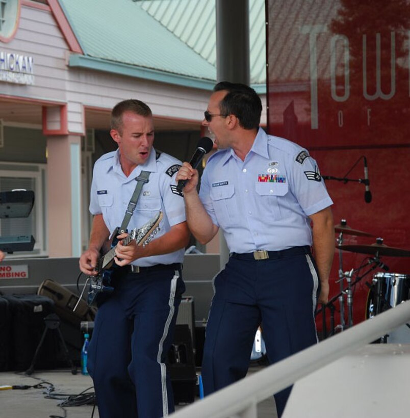 MILILANI, Hawaii -- (from left): SrA Aaron Kusterer and SrA Devin Rivas-Martin, Band of the Pacific-Hawaii, rock out to " Runaway Baby" at the Mililani Concert Series in Mililani,Hawaii, Aug. 9, 2013. The Band of the Pacific-Hawaii participated in three summer concerts in Mililani. The concert series helped build stronger community relations with the town, and the hundreds of people who attended the concerts.

(US Air Force Photo/Ms. Nicolle Euredjian/ released)