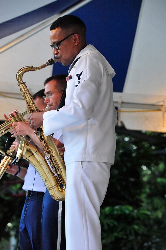 JOINT BASE PEARL HARBOR-HICKAM, Hawaii -- Musician 3rd Class Jason Gay, Navy Fleet Band, performs an amazing saxophone solo on Joint Base Pearl Harbor-Hickam, Hawaii, Aug. 23, 2013. The United States Air Force Band of the Pacific-Hawaii and the Navy Fleet Band performed two joint concerts over the summer to an audience of about 1,500 people. The joint concerts build strong relations between the Navy and Air force, while narrowing the gap between the Hickam and Pearl Harbor sides of the base. 

(US Air Force Photo/ SSgt Courtney Clifford/ released)