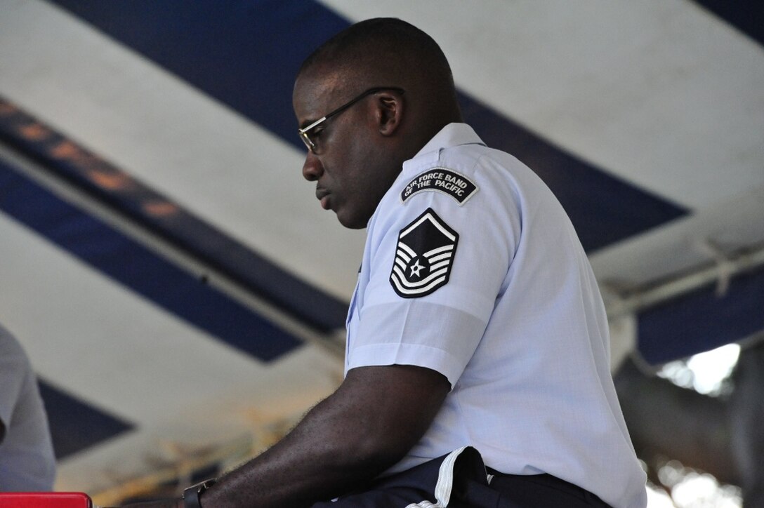 JOINT BASE PEARL HARBOR-HICKAM, Hawaii -- Master Sergeant Darryl McEachin tickles the ivory at the joint concert on Joint Base Pearl Harbor-Hickam, Hawaii, Aug. 23, 2013. The United States Air Force Band of the Pacific-Hawaii and the Navy Fleet Band performed two joint concerts over the summer to an audience of about 1,500 people. The joint concerts build strong relations between the Navy and Air force, while narrowing the gap between the Hickam and Pearl Harbor sides of the base. 

(US Air Force Photo/ SSgt Courtney Clifford/ released)