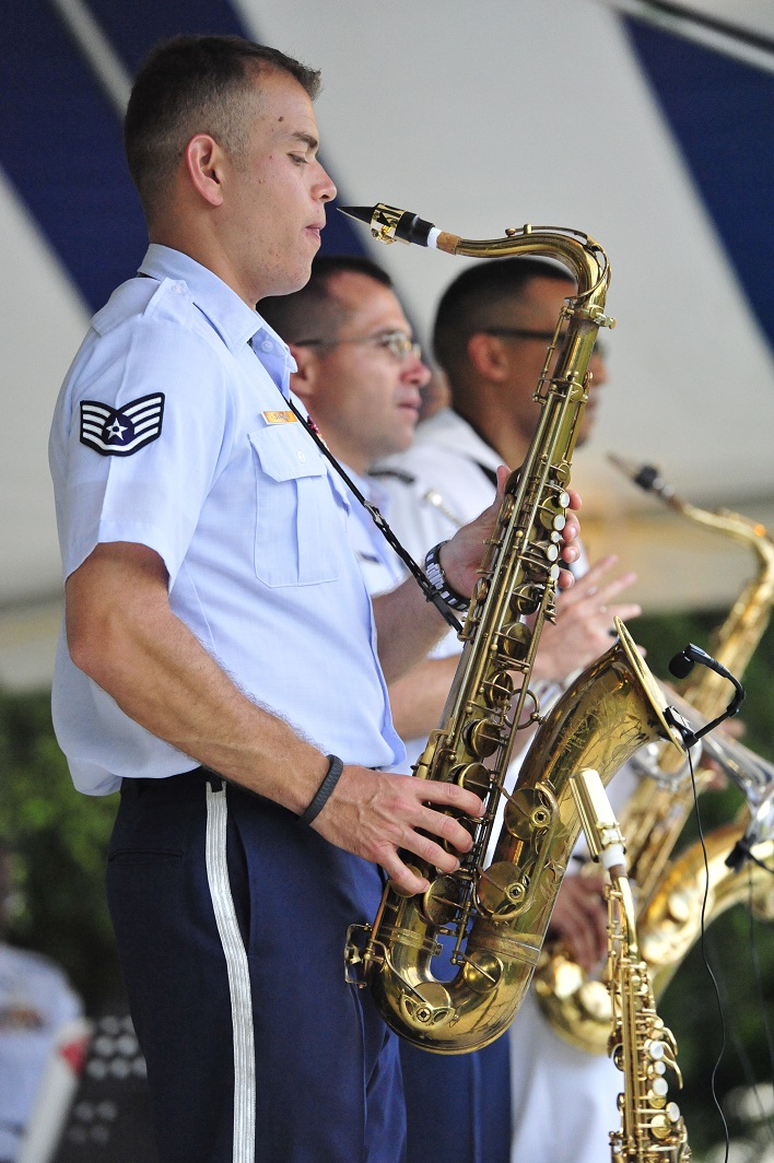 JOINT BASE PEARL HARBOR-HICKAM, Hawaii -- Staff Sergeant Miles Hudlow, Band of the Pacific-Hawaii, performs on the alto saxophone during the concert on Joint Base Pearl Harbor-Hickam, Hawaii, Aug. 23, 2013. The United States Air Force Band of the Pacific-Hawaii and the Navy Fleet Band performed two joint concerts over the summer to an audience of about 1,500 people. The joint concerts build strong relations between the Navy and Air force, while narrowing the gap between the Hickam and Pearl Harbor sides of the base. 

(US Air Force Photo/ SSgt Courtney Clifford/ released)