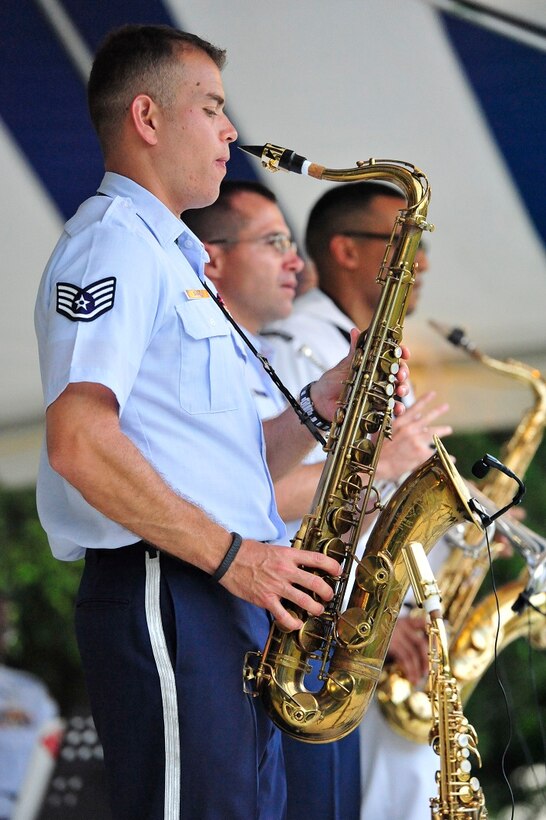 JOINT BASE PEARL HARBOR-HICKAM, Hawaii -- Staff Sergeant Miles Hudlow, Band of the Pacific-Hawaii, performs on the alto saxophone during the concert on Joint Base Pearl Harbor-Hickam, Hawaii, Aug. 23, 2013. The United States Air Force Band of the Pacific-Hawaii and the Navy Fleet Band performed two joint concerts over the summer to an audience of about 1,500 people. The joint concerts build strong relations between the Navy and Air force, while narrowing the gap between the Hickam and Pearl Harbor sides of the base. 

(US Air Force Photo/ SSgt Courtney Clifford/ released)