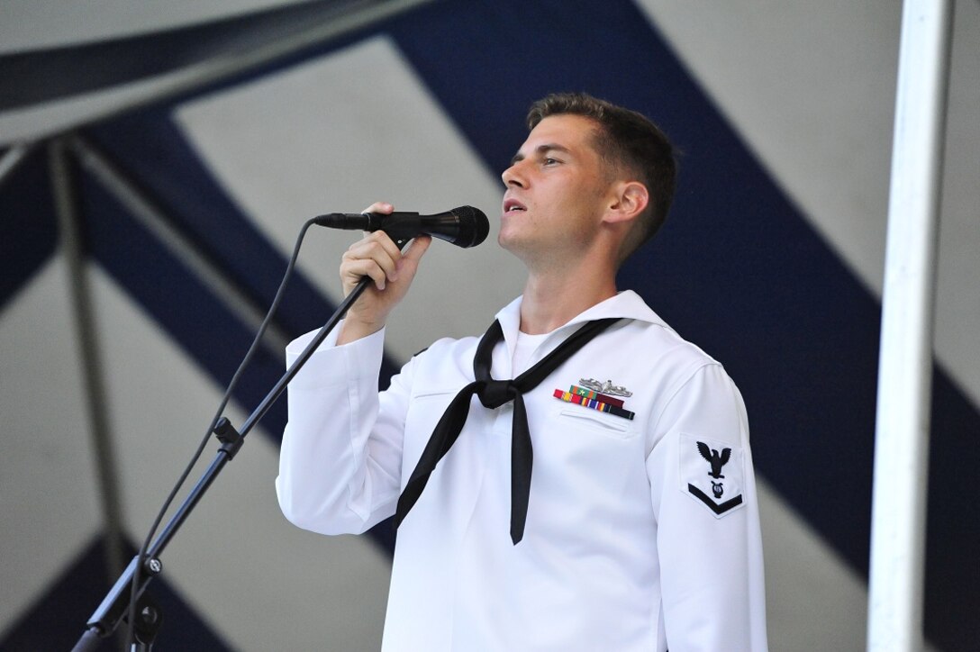 JOINT BASE PEARL HARBOR-HICKAM, Hawaii -- Musician 3rd Class Steven LaMonica, Navy Pacific Fleet Band, sings " Wind Cries Marry" during the concert on Joint Base Pearl Harbor-Hickam, Hawaii, Aug. 23, 2013. The United States Air Force Band of the Pacific-Hawaii and the Navy Fleet Band performed two joint concerts over the summer to an audience of about 1,500 people. The joint concerts build strong relations between the Navy and Air force, while narrowing the gap between the Hickam and Pearl Harbor sides of the base. 

(US Air Force Photo/ SSgt Courtney Clifford/ released)