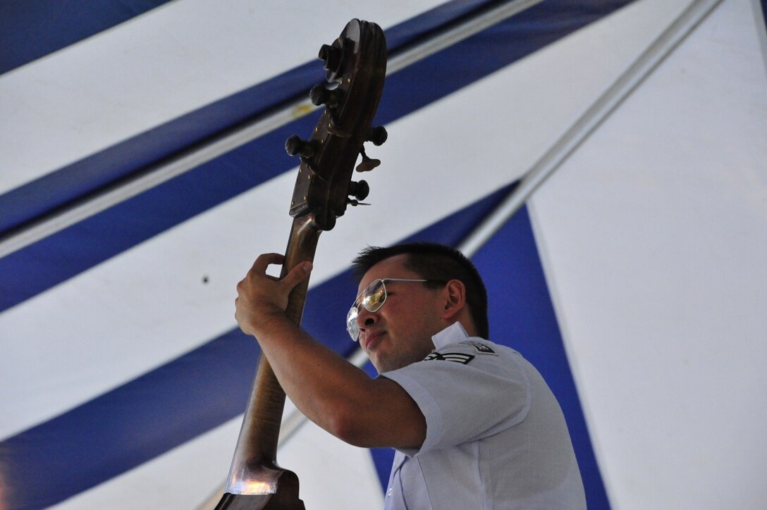 JOINT BASE PEARL HARBOR-HICKAM, Hawaii -- Senior Airman Phil Runge, Band of the Pacific-Hawaii and Musical Director of "Papapa", plays the upright bass during a joint band concert at Joint Base Pearl Harbor-Hickam, Hawaii, Aug. 23, 2013. The United States Air Force Band of the Pacific-Hawaii and the Navy Fleet Band performed two joint concerts over the summer to an audience of about 1,500 people. The joint concerts build strong relations between the Navy and Air force, while narrowing the gap between the Hickam and Pearl Harbor sides of the base. 

(US Air Force Photo/ SSgt Courtney Clifford/ released)