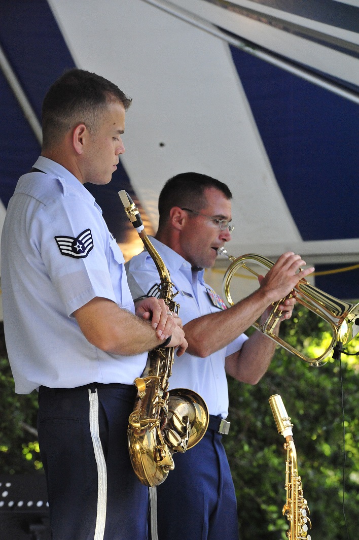 JOINT BASE PEARL HARBOR-HICKAM, Hawaii -- Technical Sergeant David Diamond, Band of the Pacific-Hawaii, background, solos on the cornet during a joint band concert at Joint Base Pearl Harbor-Hickam, Hawaii, Aug. 23, 2013. The United States Air Force Band of the Pacific-Hawaii and the Navy Fleet Band performed two joint concerts over the summer to an audience of about 1,500 people. The joint concerts build strong relations between the Navy and Air force, while narrowing the gap between the Hickam and Pearl Harbor sides of the base. 

(US Air Force Photo/ SSgt Courtney Clifford/ released)