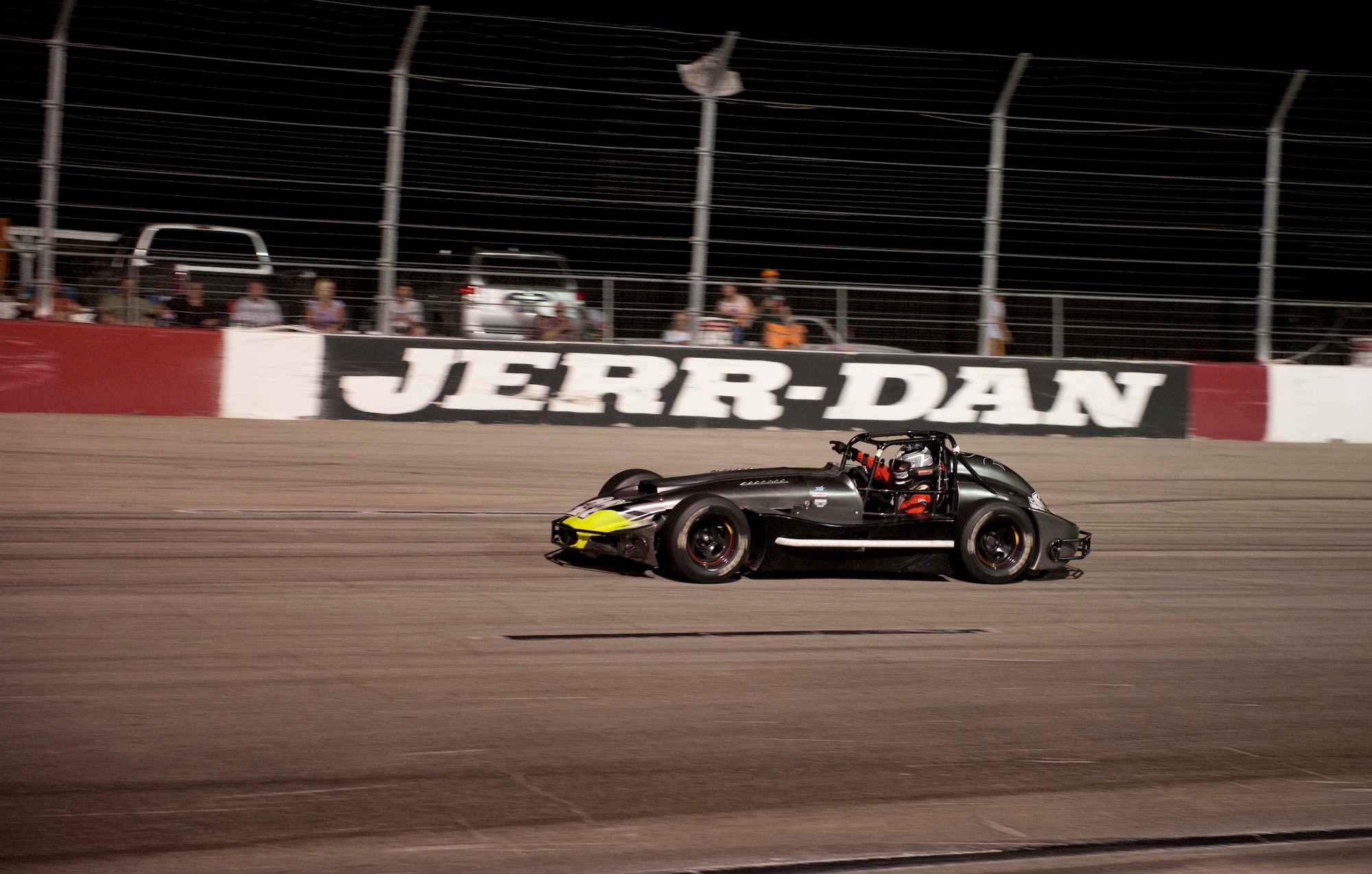 Number 21 Thunder Roadster Ian Anderson points at the crowd during his victory lap Aug. 24, 2013, at the Las Vegas Motor Speedway Bullring, Las Vegas. This lap, driven at reduced speed, allows Ian to celebrate his victory. Ian is the son of Master Sgt. Cristy Anderson, 53rd Test and Evaluation Group first sergeant. (U.S. Air Force photo by Airman 1st Class Timothy Young)