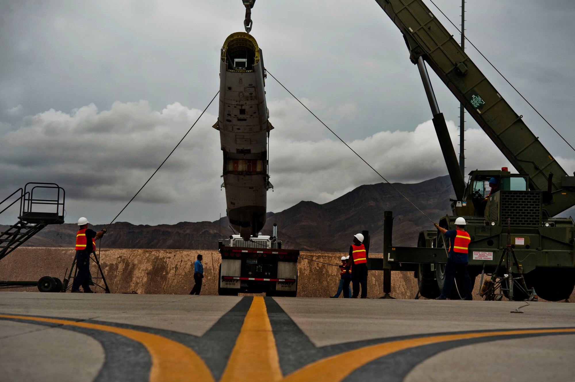 Members from the 57th Maintenance Squadron crash recovery team guide the fuselage of an A-10 Thunderbolt II from the 57th Aircraft Maintenance Squadron Thunder Aircraft Maintenance Unit Aug. 26, 2013, at Nellis Air Force Base, Nev. The fuselage will be taken to the Nevada Test and Training Range where it will be used as an air to ground target for pilots during training missions. (U.S. Air Force photo by Senior Airman Daniel Hughes)