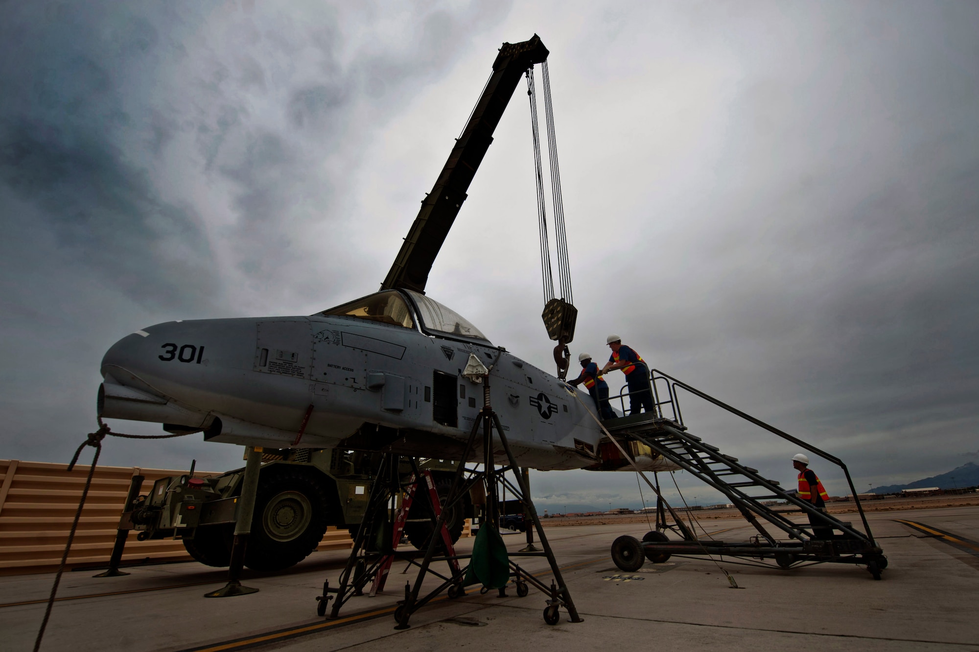 Members from the 57th Maintenance Squadron crash recovery team guide the fuselage of an A-10 Thunderbolt II from the 57th Aircraft Maintenance Squadron Thunder Aircraft Maintenance Unit Aug. 26, 2013, at Nellis Air Force Base, Nev. The fuselage will be taken to the Nevada Test and Training Range where it will be used as an air to ground target for pilots during training missions. (U.S. Air Force photo by Senior Airman Daniel Hughes)