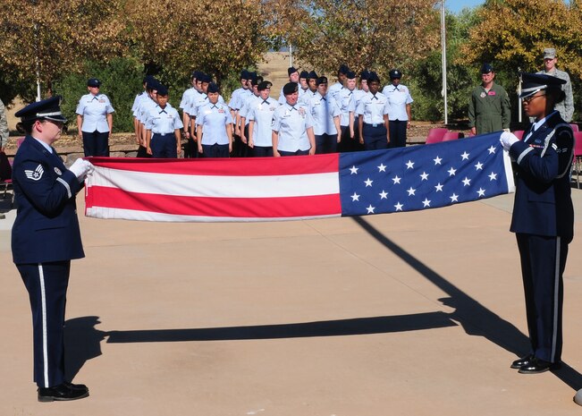 An all-female honor guard team folds the flag during a retreat ceremony honoring Women’s Equality Day at Beale Air Force Base, Calif., Aug. 26, 2013. The observance of Women’s Equality Day not only commemorates the passage of the 19th Amendment but also calls attention to women’s continuing efforts toward full equality. (U.S. Air Force photo by Senior Airman Allen Pollard/Released)