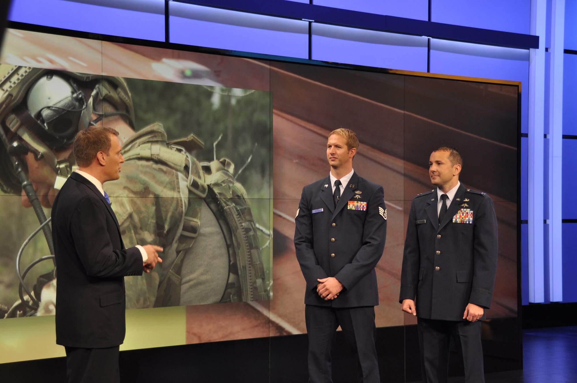 Mike Bettes, The Weather Channel TV personality, interviews Staff Sgt. Travis Sanford, Special Tactics Training Squadron instructor, and Capt. Jonathan Sawtelle, 10th Combat Weather Squadron operations officer, during the "Morning Rush" show Aug. 23, 2013 in Atlanta, Ga. The interview showcased the Special Operations Weather Team career field and the impact weather can have in planning for combat operations. (U.S. Air Force photo by Capt. Victoria Porto) 
