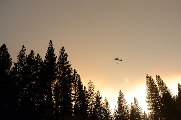 California Air National Guardsmen from the 129th Rescue Wing perform precision water bucket drops in support of the Rim Fire suppression operation at Tuolumne County near Yosemite, Calif., Aug. 26, 2013.  (Courtesy photo by Staff Sgt. Ed Drew)