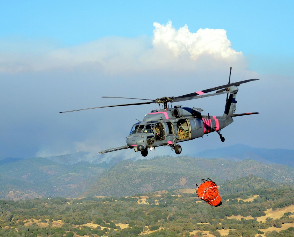 California Air National Guardsmen from the 129th Rescue Wing perform precision water bucket drops in support of the Rim Fire suppression operation at Tuolumne County near Yosemite, Calif., Aug. 26, 2013.  (Courtesy photo by Staff Sgt. Ed Drew)