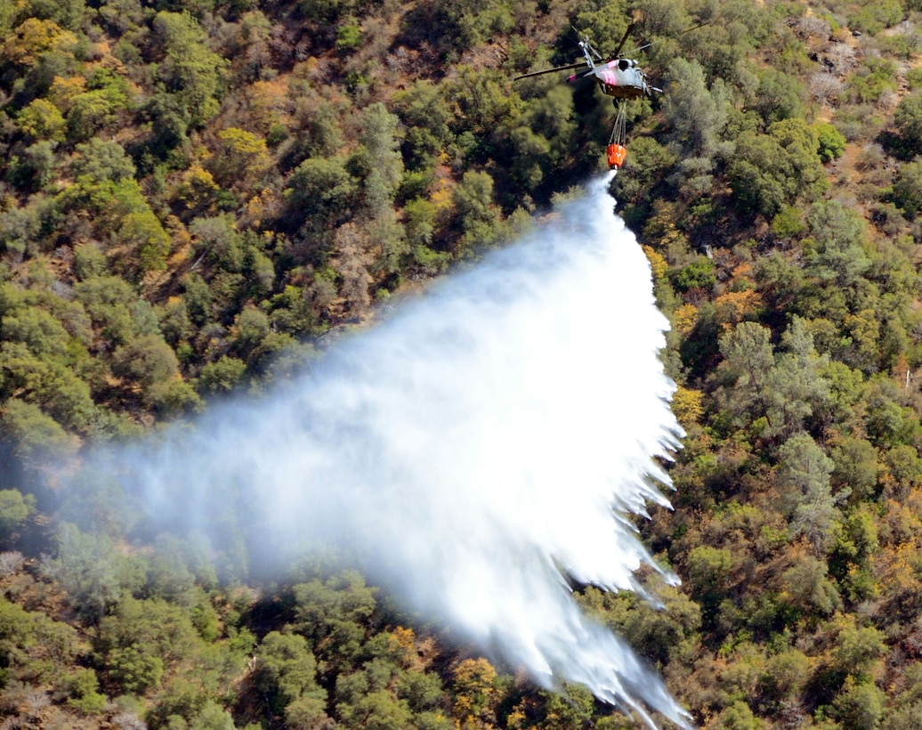 California Air National Guardsmen from the 129th Rescue Wing perform precision water bucket drops in support of the Rim Fire suppression operation at Tuolumne County near Yosemite, Calif., Aug. 26, 2013.  (Courtesy photo by Staff Sgt. Ed Drew)