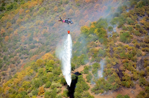 California Air National Guardsmen from the 129th Rescue Wing perform precision water bucket drops in support of the Rim Fire suppression operation at Tuolumne County near Yosemite, Calif., Aug. 26, 2013.  (Courtesy photo by Staff Sgt. Ed Drew)
