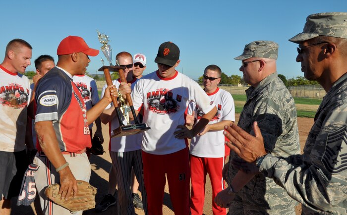 Lt. Col. Jon Rucker, 9th Force Support Squadron commander, and Chief Master Sgt. Leslie Gould, 9th Reconnaissance Wing command chief, present the 9th Munitions Squadron softball team with 2013 Intramural Softball Championship Trophy at O’Malley Field on Beale Air Force Base, Calif., Aug. 26, 2013. 9th MUNS defeated 9th Civil Engineer Squadron, 26-9. (U.S. Air Force photo by Staff Sgt. Robert M. Trujillo/Released)