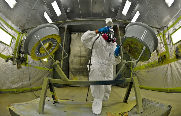 Airman 1st Class Eric Martinez, 6th Maintenance Squadron structures technician uses a newly designed wheel workstation (WWS) to paint a KC-135 Stratotanker wheel, Aug 27, 2013 at MacDill Air Force Base, Fla. The implementation of the WWS reduced the paint process time by 26 hours per set. (U.S. Air Force photo/Staff Sgt. Brandon Shapiro)