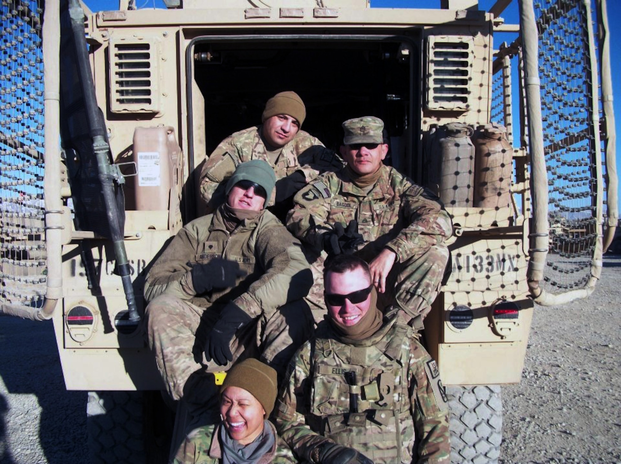 Air Force Staff Sgt. Maria Szymanski, a 366th Surgical Operations Squadron medical technician (bottom), poses with her five-person convoy team before a May 29-30, 2013 convoy from Bagram Airfield, Afghanistan, to forward operating bases and combat outposts in Wardak Province. The next day, during day two of the mission, the vehicle Szymanski was supposed to ride in, struck an improvised explosive device, killing Army Staff Sgt. Joe Nunez, and wounding Air Force Senior Airman Taylor Savage, deployed from Charleston Air Force Base, S.C., and several others. (Courtesy photo)
