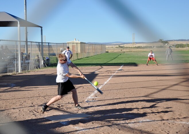 A member of the 9th Civil Engineer Squadron attempts to hit a softball at the 2013 Intramural Softball Championships at O’Malley Field on Beale Air Force Base, Calif., Aug. 26, 2013. 9th MUNS defeated 9th Civil Engineer Squadron, 26-9. (U.S. Air Force photo by Staff Sgt. Robert M. Trujillo/Released)